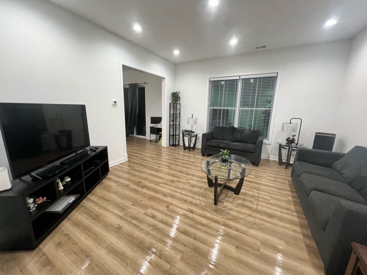 spotless living room with polished floors and neatly arranged furniture
