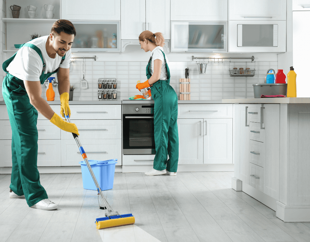 cleaners mopping and sanitizing kitchen during move in move out cleaning